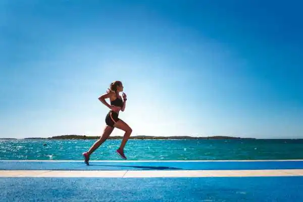 Woman running showing strong leg muscle Handsworth Wood